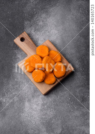 Fried chicken nuggets with sauce, salt, and spices, fast food, unhealthy food. Chicken nuggets 140165723