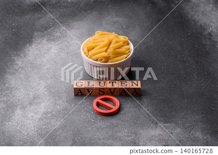 Italian uncooked dry penne regatta pasta with a gluten prohibition sign. The gluten prohibition sign Italian uncooked dry penne regatta pasta with a gluten prohibition sign. The gluten prohibition sign 140165728