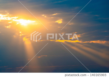 Sunset sky with sun rays through clouds 140165903