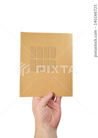 a male hand vertically holds a notebook with a multiplication table from the bottom of the cover a male hand vertically holds a notebook with a multiplication table from the bottom of the cover 140166725