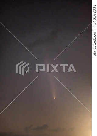 Comet ATLAS shines in the silent night sky. 140168033