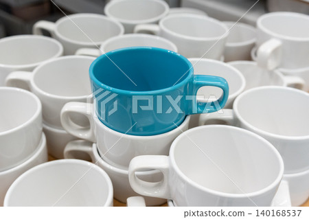 Blue cups and mugs in crockery shop, ceramic dishware, tableware stack in store 140168537