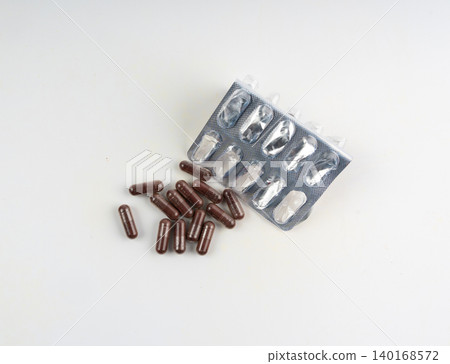 Iron capsule isolated, Fe pills, brown hemoglobin supplement tablets, vitamin capsules on white Iron capsule isolated, Fe pills, brown hemoglobin supplement tablets, vitamin capsules on white 140168572
