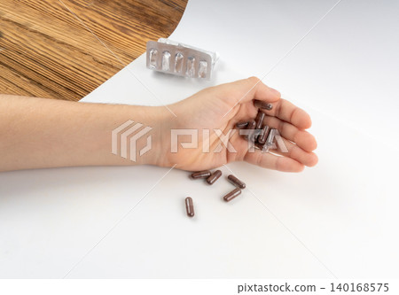 Iron capsule isolated, Fe pills, brown hemoglobin supplement tablets, vitamin capsules on white Iron capsule isolated, Fe pills, brown hemoglobin supplement tablets, vitamin capsules on white 140168575