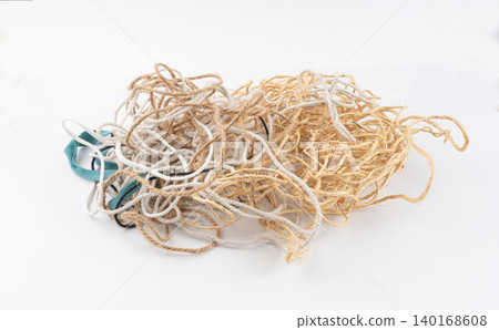 String piece isolated, jute rope fragment, part of packaging cord knots, eco-friendly natural rope 140168608