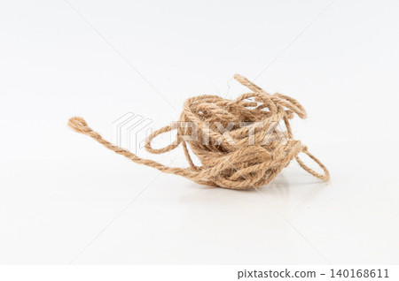 String piece isolated, jute rope fragment, part of packaging cord knots, eco-friendly natural rope String piece isolated, jute rope fragment, part of packaging cord knots, eco-friendly natural rope 140168611