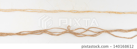 Twine rope piece isolated, jute loop fragment, beige packaging cord knots, old natural line cable Twine rope piece isolated, jute loop fragment, beige packaging cord knots, old natural line cable 140168612