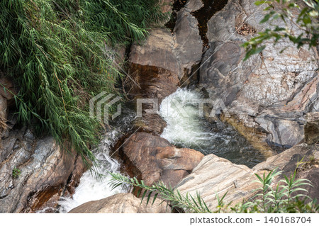 A warm mountain river and a small waterfall A warm mountain river and a small waterfall 140168704