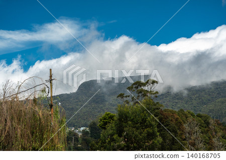 A cloud on a green mountain in the central part of Sri Lanka A cloud on a green mountain in the central part of Sri Lanka 140168705