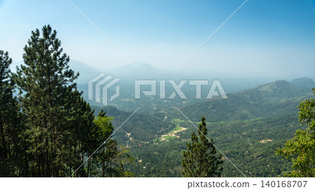 Lush greenery and small houses in a valley Lush greenery and small houses in a valley 140168707