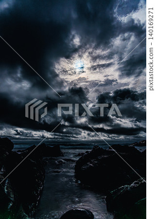 月光籠罩著夜幕下的大海,雲朵呈現出雄偉壯麗的景象。 月光籠罩著夜幕下的大海,雲朵呈現出雄偉壯麗的景象。 140169271