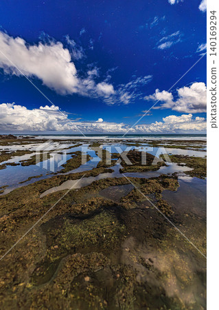 The night sky reflected in the tide pools, with the constellation Orion visible on the coast of Tanegashima Island. The night sky reflected in the tide pools, with the constellation Orion visible on the coast of Tanegashima Island. 140169294