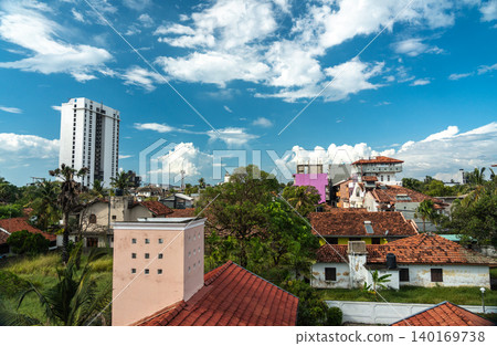 View of old tiled roofs and lush tropical greenery, editorial image View of old tiled roofs and lush tropical greenery, editorial image 140169738