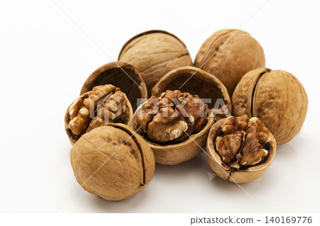 Walnut shells against a white background Walnut shells against a white background 140169776