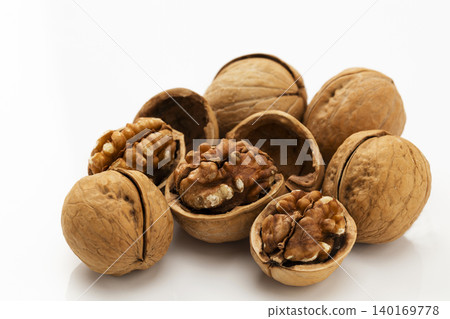 Walnut shells against a white background Walnut shells against a white background 140169778