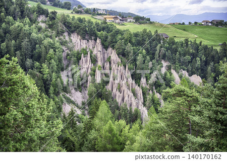 Earth pyramids rising from green forest in South Tyrol, Italy Earth pyramids rising from green forest in South Tyrol, Italy 140170162