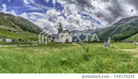 Small church standing on a green meadow, Italian Alps 140170201