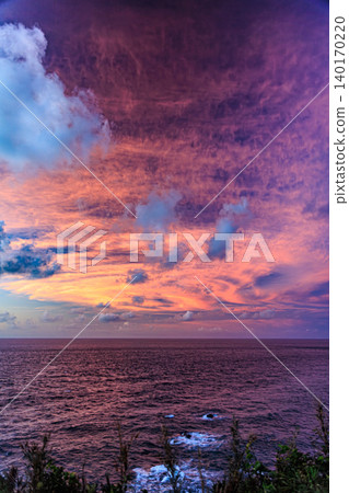 A beautiful sunrise view of Kadokura Cape on Tanegashima Island, illuminating the Pacific Ocean. A beautiful sunrise view of Kadokura Cape on Tanegashima Island, illuminating the Pacific Ocean. 140170220