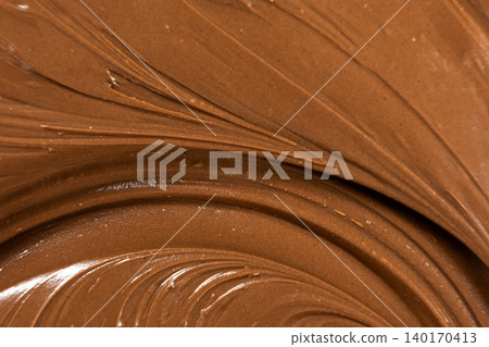 Macro texture of glossy chocolate nut cream swirling patterns 140170413