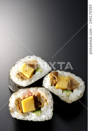 Eel sushi roll photographed against a black background Eel sushi roll photographed against a black background 140170565