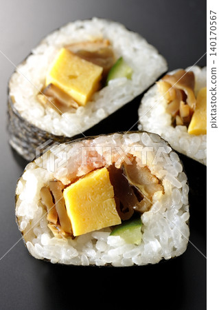 Eel sushi roll photographed against a black background Eel sushi roll photographed against a black background 140170567