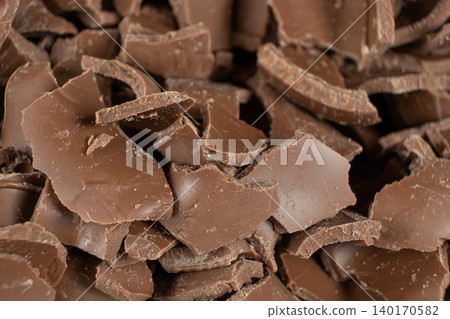 Macro texture of broken milk chocolate pieces pile background Macro texture of broken milk chocolate pieces pile background 140170582