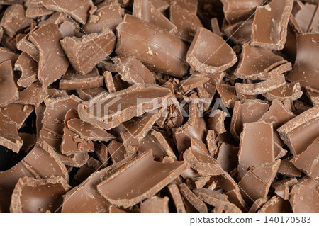Macro texture of broken milk chocolate pieces pile background Macro texture of broken milk chocolate pieces pile background 140170583