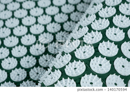 Macro abstract background of green acupuncture massage mat needles. 140170594