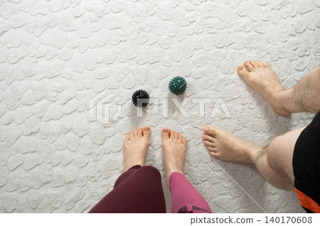 Couple Practicing Foot Massage with Spiky Therapy Balls Couple Practicing Foot Massage with Spiky Therapy Balls 140170608