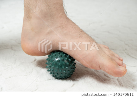 Flat feet prevention and plantar fasciitis relief massage with a ball Flat feet prevention and plantar fasciitis relief massage with a ball 140170611