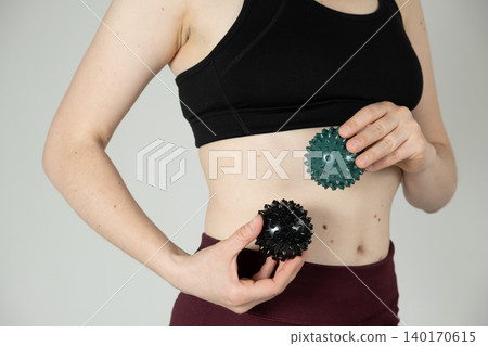 Woman Holding Massage Balls for Recovery and Wellness Woman Holding Massage Balls for Recovery and Wellness 140170615