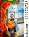 Little boy riding colorful carousel turtle shopping mall amusement area bright decorations 140170728