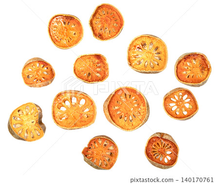 Scattered slices of dried bael fruit isolated. Traditional herbal medicine ingredient for healthy tea and wellness. Aegle marmelos fruit pieces seen from a top view. Scattered slices of dried bael fruit isolated. Traditional herbal medicine ingredient for healthy tea and wellness. Aegle marmelos fruit pieces seen from a top view. 140170761