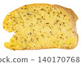 Single slice of fresh bread spread with creamy garlic butter and aromatic dried herbs, isolated. Top view close-up of a delicious toasted appetizer or side dish. 140170768