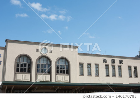 The retro Showa-era west exit station building of Ryogoku Station on the JR Sobu Line stands out against the blue sky. The retro Showa-era west exit station building of Ryogoku Station on the JR Sobu Line stands out against the blue sky. 140170795