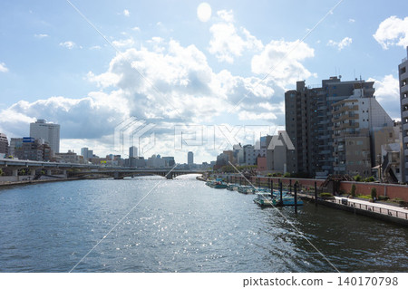 A waterfront scene of the Sumida River, where the summer sunlight sparkles on the water's surface. A waterfront scene of the Sumida River, where the summer sunlight sparkles on the water's surface. 140170798