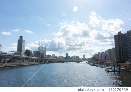 The urban landscape of the Sumida River Terrace and the cluster of apartment buildings towering along the river. The urban landscape of the Sumida River Terrace and the cluster of apartment buildings towering along the river. 140170799
