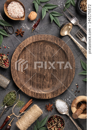 Rustic Culinary Flat-Lay with Vintage Silverware, Spices, and Empty Plate on Stone Background Rustic Culinary Flat-Lay with Vintage Silverware, Spices, and Empty Plate on Stone Background 140170872