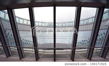 Modern architectural interior with large glass windows and curved structure Modern architectural interior with large glass windows and curved structure 140171928