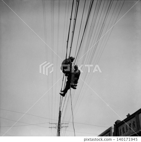 Vintage photograph, 1943, Manchuria during the Second Sino-Japanese War: Soldiers of the 3108th Manchurian Unit working on electrical wiring. Vintage photograph, 1943, Manchuria during the Second Sino-Japanese War: Soldiers of the 3108th Manchurian Unit working on electrical wiring. 140171945
