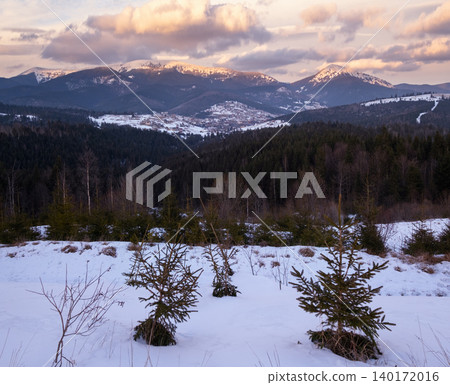 Winter evening sunset mountains (Ukraine, Carpathians - mountain peaks Khomyak and Synyak scenery view from Yablunytsia Pass). Winter evening sunset mountains (Ukraine, Carpathians - mountain peaks Khomyak and Synyak scenery view from Yablunytsia Pass). 140172016