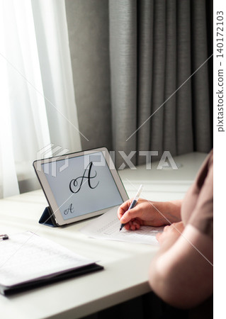 Person seated at desk deeply focused on writing in notebook. Physical engagement of motor skills Handwriting as brain training. Prevention of age related cognitive decline. Senior or adult practicing Person seated at desk deeply focused on writing in notebook. Physical engagement of motor skills Handwriting as brain training. Prevention of age related cognitive decline. Senior or adult practicing 140172103