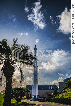 The N-I rocket at Tanegashima Space Center stands out against the blue sky and palm trees of the tropics. 140172398