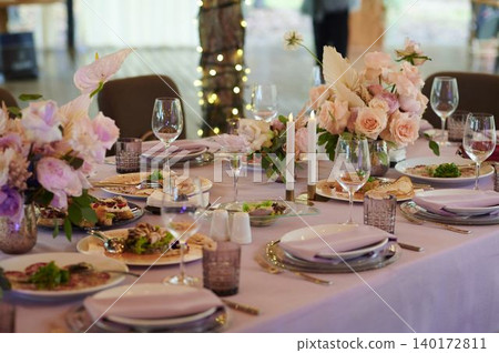 Chic outdoor dining with floral decor Chic outdoor dining with floral decor 140172811