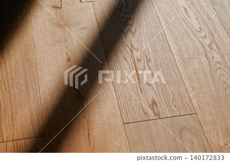 Sunlight dances on polished wooden floor Sunlight dances on polished wooden floor 140172833