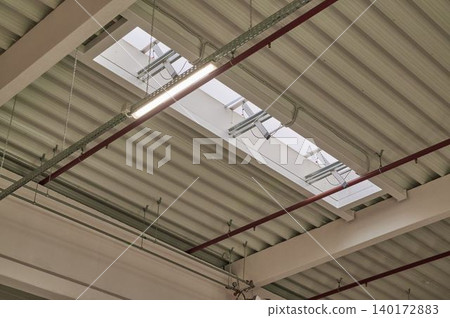 Light beams through industrial ceiling 140172883