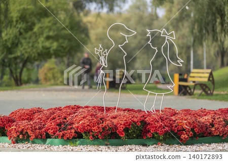 Couple in a garden of flowers during autumn season Couple in a garden of flowers during autumn season 140172893