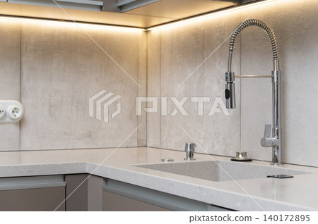 Modern kitchen sink with sleek design features 140172895