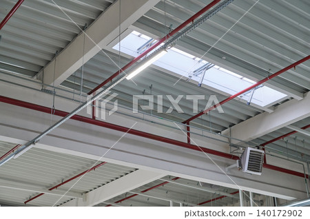 Sunlight filters through industrial ceilings Sunlight filters through industrial ceilings 140172902