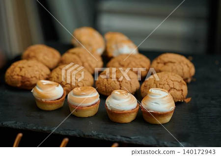 Delicious desserts on a black slate surface Delicious desserts on a black slate surface 140172943